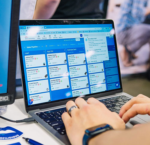 person using jobnimbus boards feature on a laptop