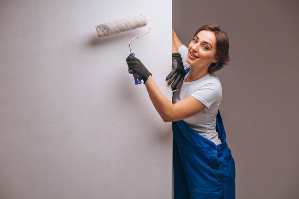 Woman with paint roller about to paint a wall