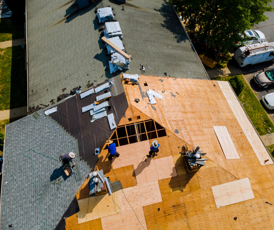roofing contractors working on roofing shingles aerial view