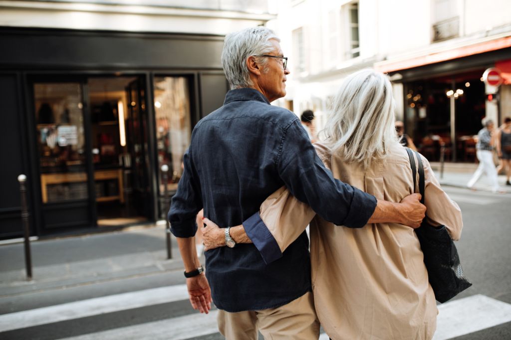 A retired couple walking in a city street
